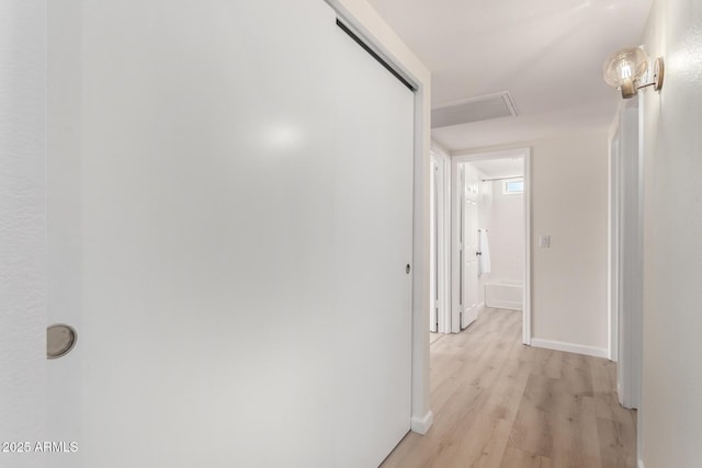 12529 N 83rd Ln, Peoria, AZ 85381 - hallway featuring light wood-type flooring, baseboards, and attic access