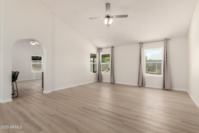 12529 N 83rd Ln, Peoria, AZ 85381 - spare room with a ceiling fan, healthy amount of natural light, arched walkways, light wood-type flooring, and high vaulted ceiling