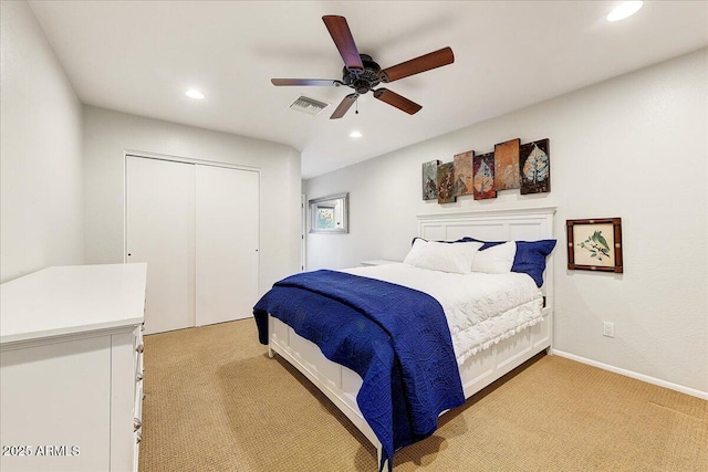 bedroom featuring light carpet, a closet, and ceiling fan