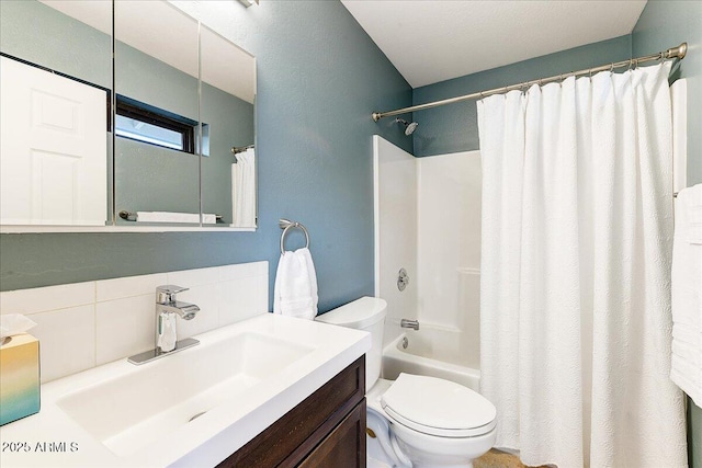 full bathroom featuring vanity, shower / bath combo, backsplash, and toilet