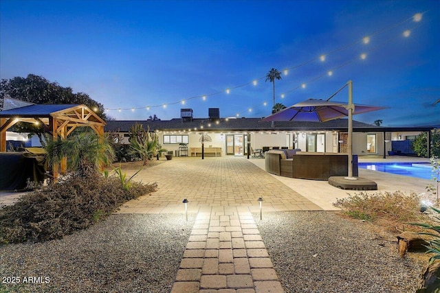 exterior space featuring a swimming pool, outdoor lounge area, and a patio