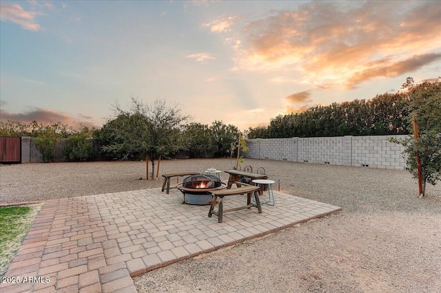 patio terrace at dusk with a fire pit