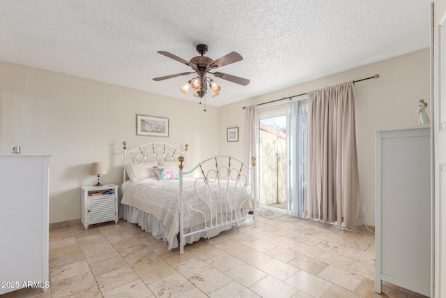 bedroom featuring a textured ceiling and ceiling fan