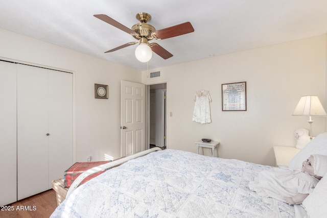 bedroom featuring a closet, hardwood / wood-style flooring, and ceiling fan