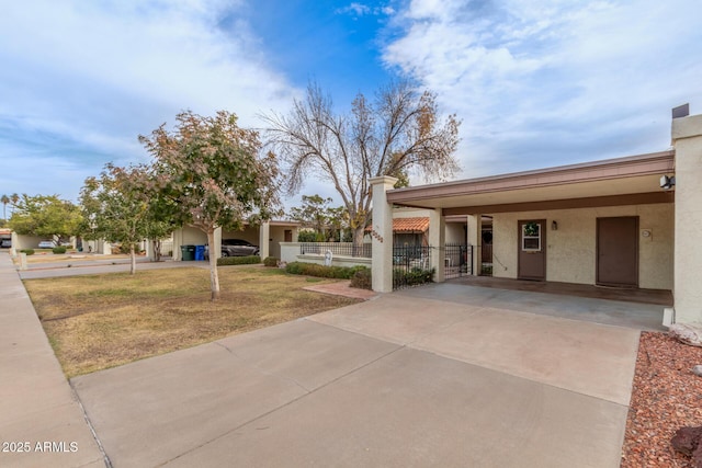 view of front of house with a front lawn and a carport