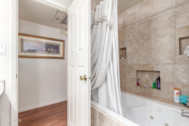 bathroom featuring wood-type flooring and shower / tub combo with curtain