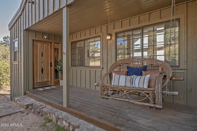 view of exterior entry featuring covered porch