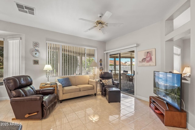 living room featuring light tile patterned floors and ceiling fan