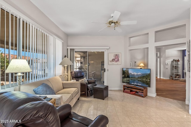 living room with light tile patterned flooring and ceiling fan