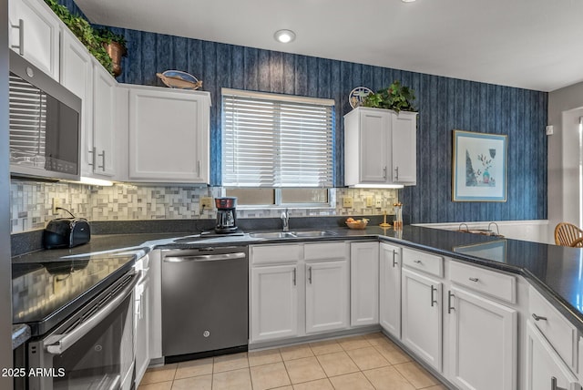 kitchen with sink, stainless steel appliances, and white cabinets