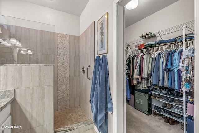 bathroom featuring vanity and a tile shower