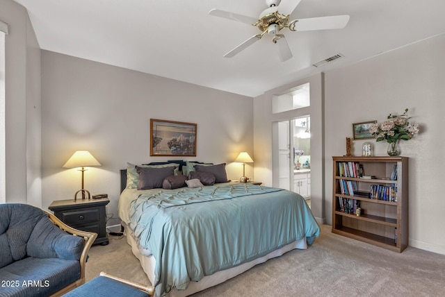 carpeted bedroom featuring ceiling fan and ensuite bathroom