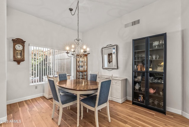 dining space featuring a chandelier and light wood-type flooring