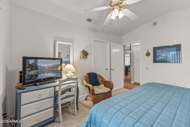 carpeted bedroom with ceiling fan and vaulted ceiling