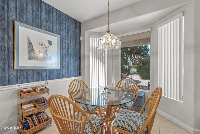 tiled dining area with an inviting chandelier