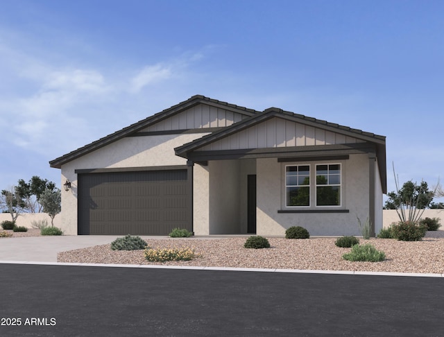 view of front of house featuring a garage, concrete driveway, and stucco siding