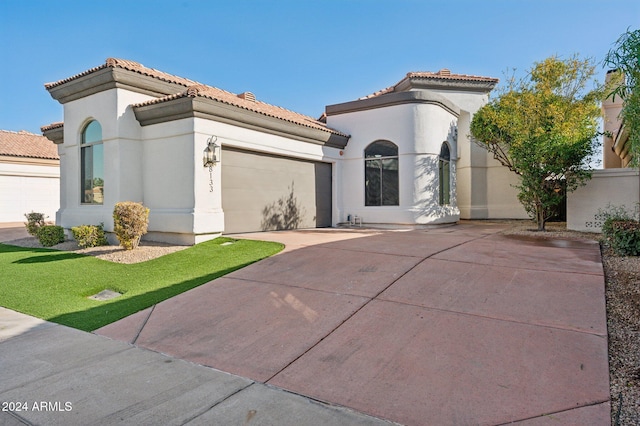 mediterranean / spanish-style home featuring a garage