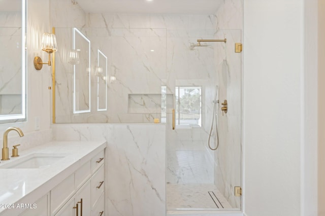 bathroom featuring vanity and a shower with shower door