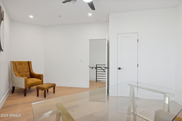 sitting room with ceiling fan and light hardwood / wood-style floors