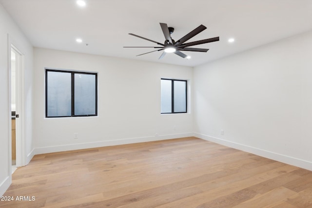 spare room featuring light wood-type flooring and ceiling fan