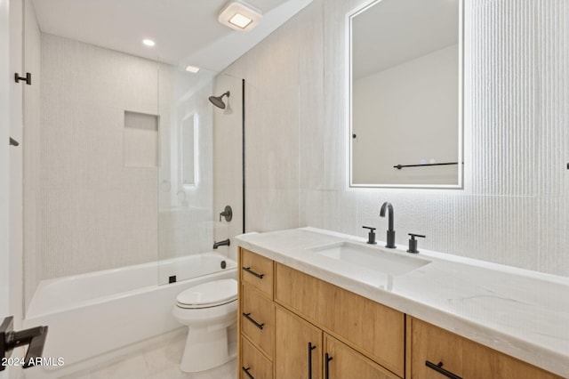 full bathroom featuring vanity, tile patterned flooring, tiled shower / bath, and toilet