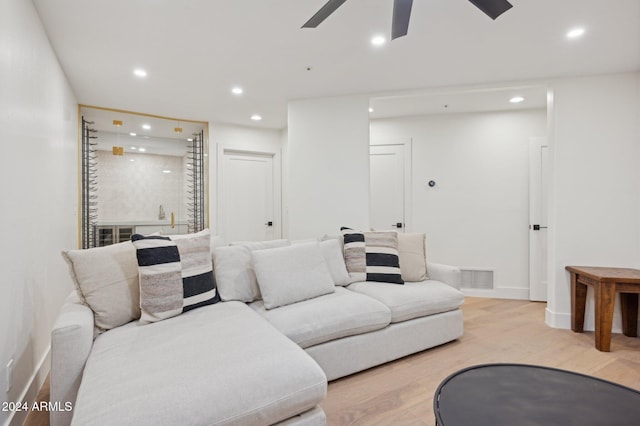 living room with ceiling fan and light wood-type flooring