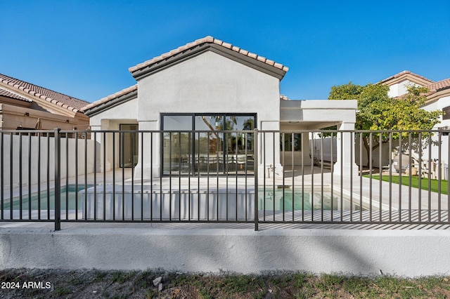 view of gate featuring a fenced in pool and a patio