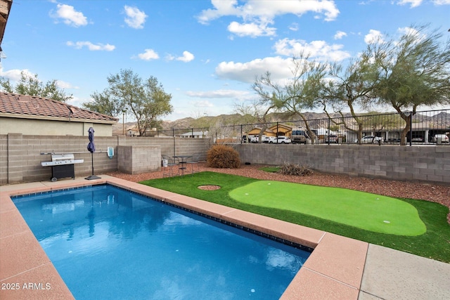 view of swimming pool featuring a fenced backyard