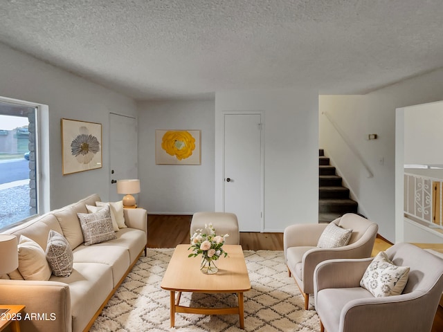 living room featuring a textured ceiling and light hardwood / wood-style flooring