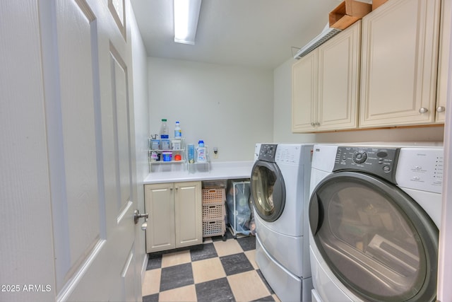 clothes washing area with tile patterned floors, independent washer and dryer, and cabinet space