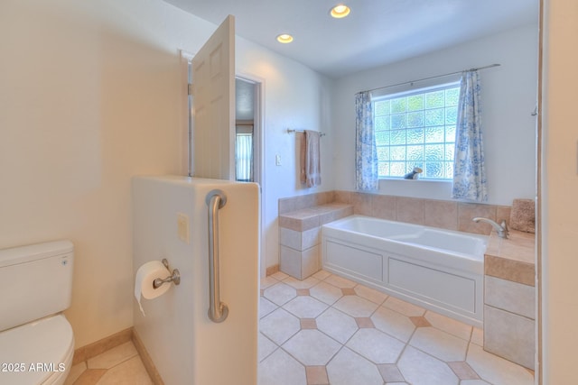 full bath featuring tile patterned floors, a garden tub, recessed lighting, and toilet