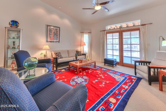 carpeted living area with lofted ceiling and ceiling fan