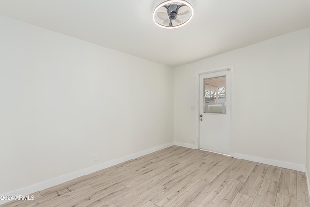 unfurnished room with light wood-type flooring