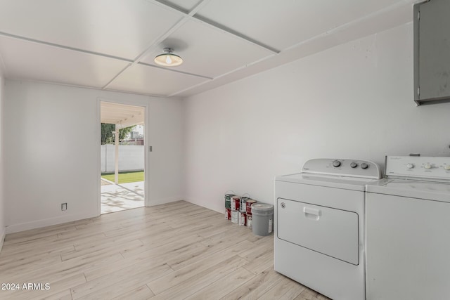 laundry room with light wood-type flooring and separate washer and dryer