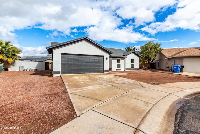 ranch-style house featuring stucco siding, an attached garage, and concrete driveway