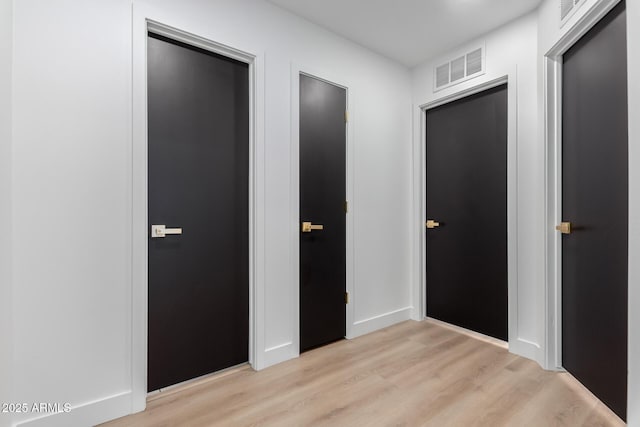 interior space featuring light wood-type flooring and visible vents