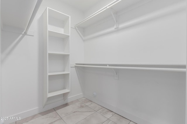 spacious closet featuring light tile patterned flooring