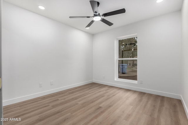 empty room with recessed lighting, a ceiling fan, light wood-style floors, and baseboards