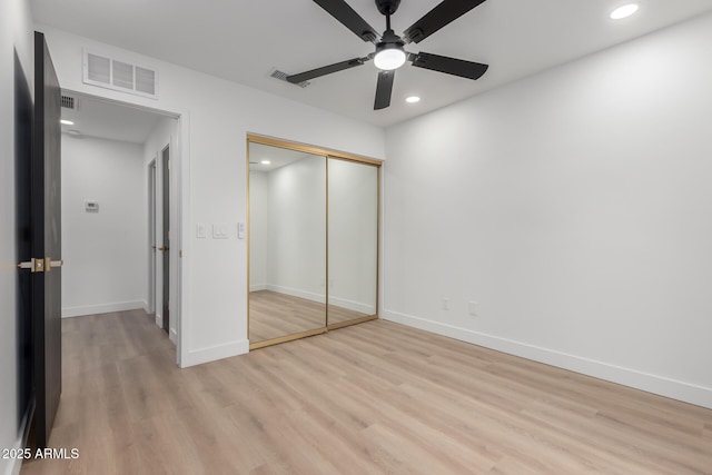 unfurnished bedroom with a closet, visible vents, light wood-style flooring, and recessed lighting