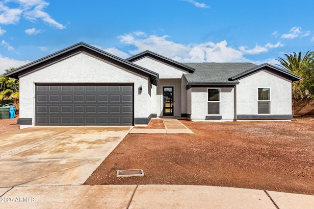 ranch-style home featuring stucco siding, a garage, roof with shingles, and driveway