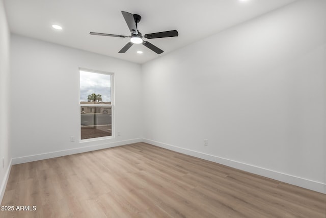 unfurnished room with recessed lighting, light wood-type flooring, and baseboards