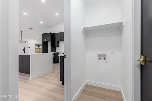 laundry area featuring recessed lighting, baseboards, hookup for a washing machine, and light wood finished floors