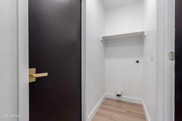 washroom featuring laundry area, light wood-style flooring, hookup for an electric dryer, and baseboards