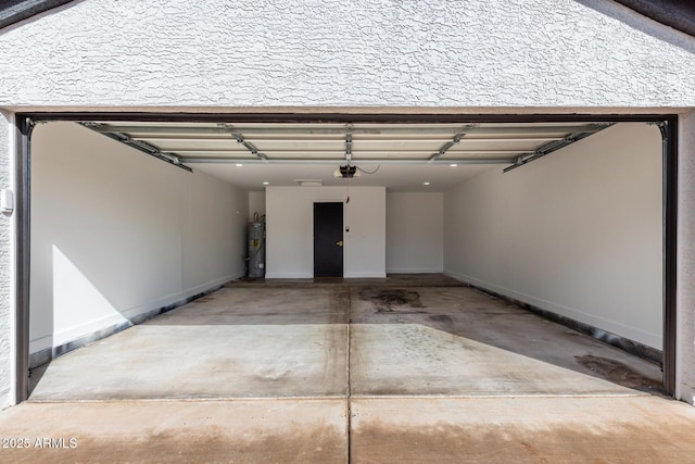 garage with concrete driveway and electric water heater