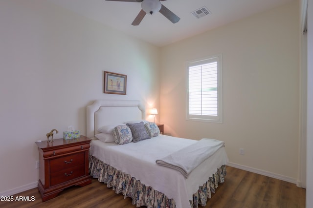 bedroom featuring dark hardwood / wood-style flooring and ceiling fan