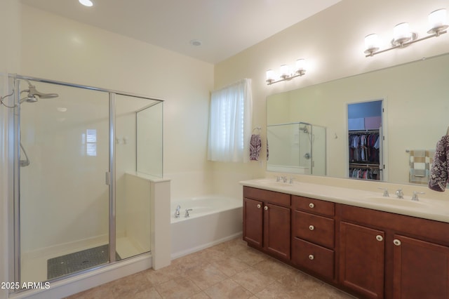 bathroom featuring vanity, tile patterned floors, and shower with separate bathtub