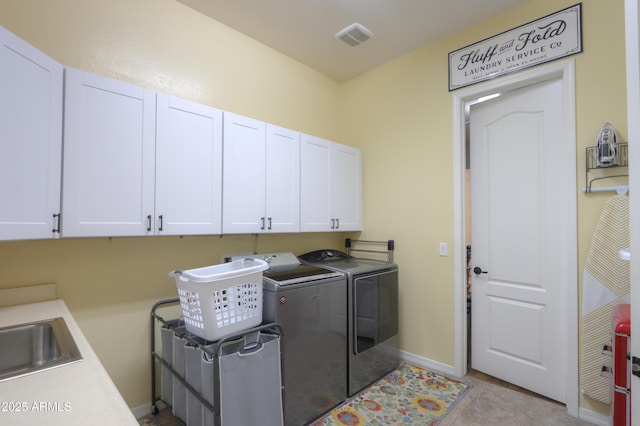 laundry area with cabinets, light tile patterned flooring, sink, and independent washer and dryer