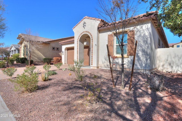 mediterranean / spanish-style house featuring a garage