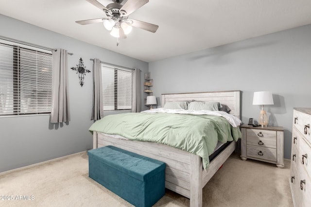 bedroom featuring light colored carpet and ceiling fan