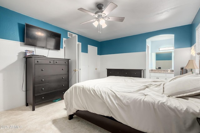 carpeted bedroom with ceiling fan and ensuite bathroom